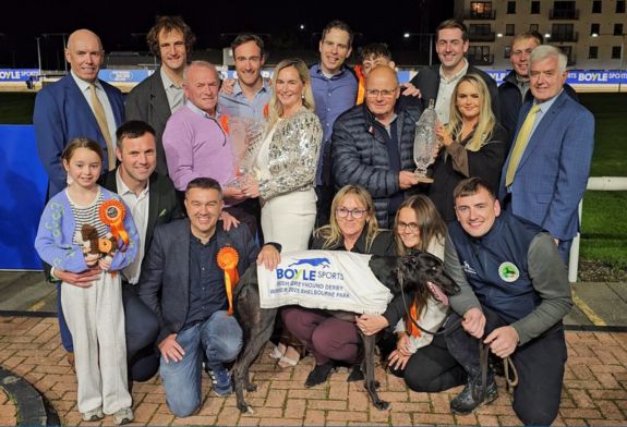 Image shows the winning presentation at the 2025 BOYLE Sports irish Greyhound Derby FInal in Shelbourne Park with the winning greyhound Cheap Sandwiches in front of a group of people