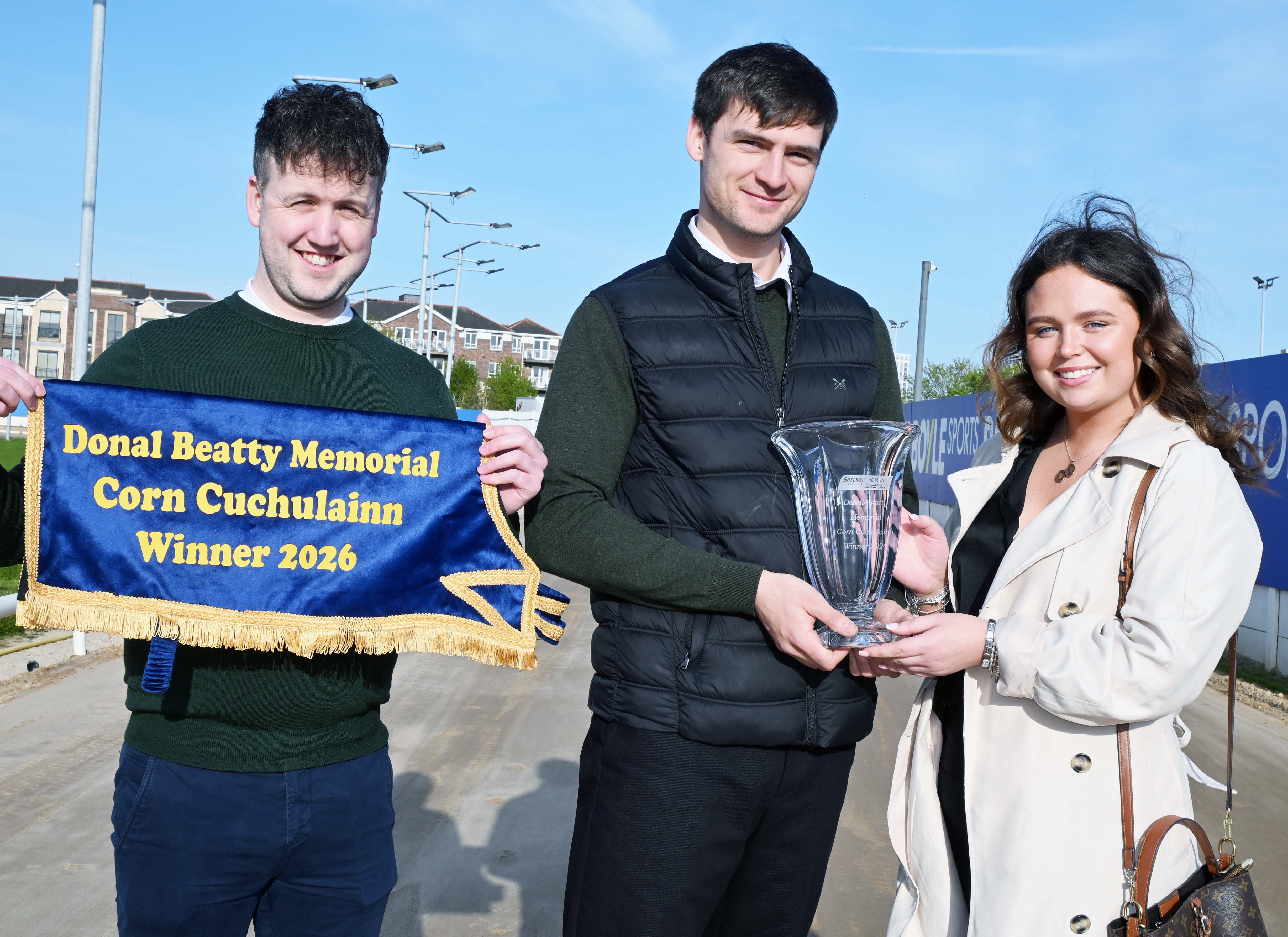 Emma Beatty, sponsor of the Donal Beatty Memorial Corn Cú Chulainn, presents the winner’s trophy to Eoin McCann, Section Manager at GRI. Also pictured is Dylan Brennan, Racing Manager, holding the presentation sheet. This is an image of three people. On the right is Emma Beatty, sponsor of the Donal Beatty Memorial Corn Cú Chulainn, presents the winner’s trophy to Eoin McCann, Section Manager at GRI. Pictured on the left is Dylan Brennan, Racing Manager, holding the presentation sheet.