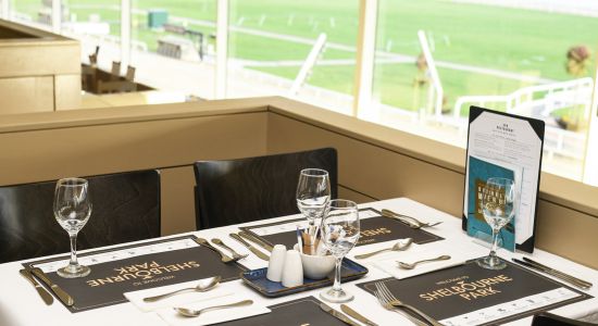 Image shows a table set for dinner service in Shelbourne Park Greyhound Stadium's restaurant overlooking the racecourse in Dublin